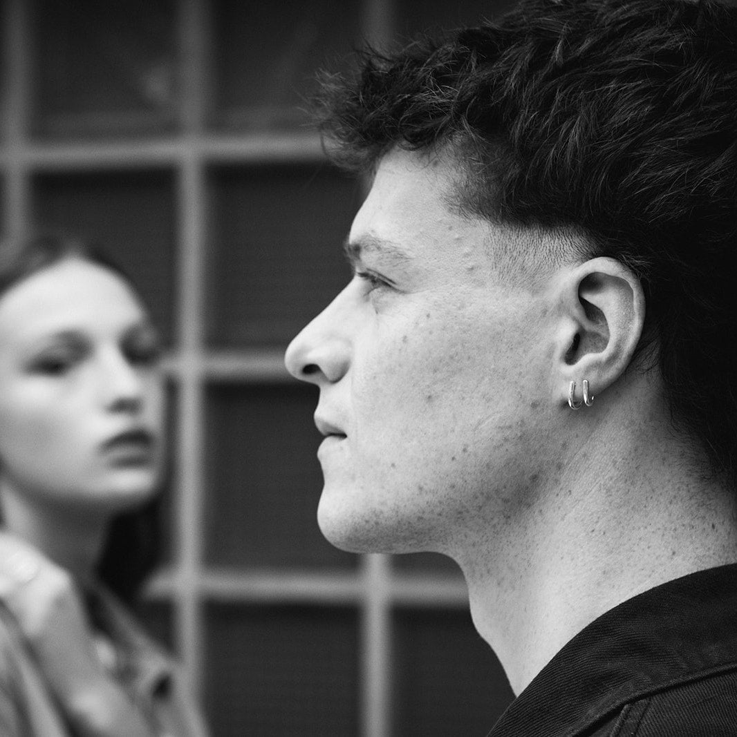 Black and white photo of a model who is wearing the Jasper earrings, designed by Aurore Havenne
